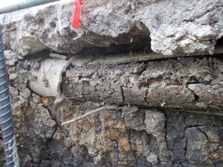 Asbestos pipe debris in soils resulting in hazardous waste classification.